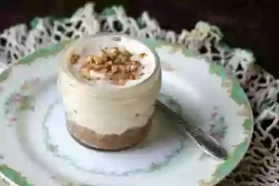 low carb caramel pecan cheesecake on a green and white vintage plate - feature image