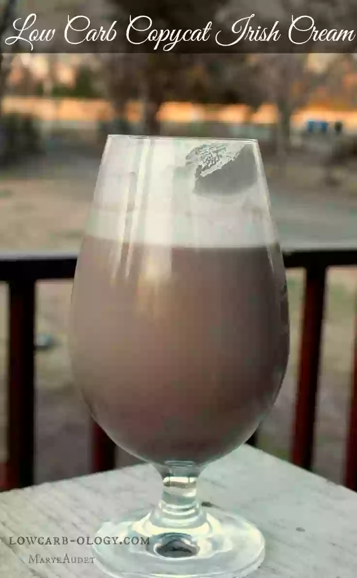 Low carb Baileys Irish Cream with a S’mores Kick in a goblet stye glass on a white table. Perfect for St. Patricks day !