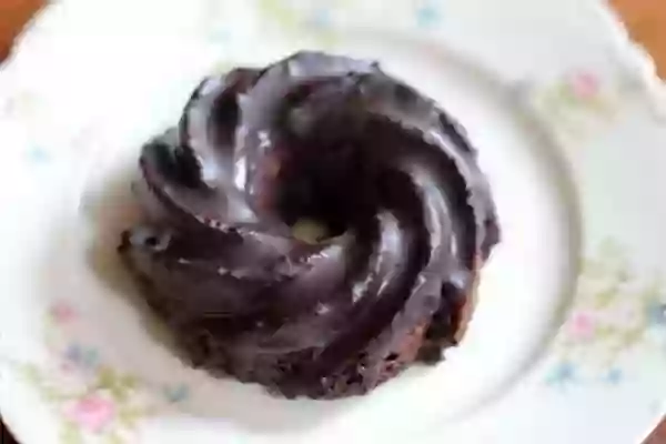 Low carb, gluten free double chocolate donuts with a shiny chocolate glaze - baked and easy. From Lowcarb-ology.com