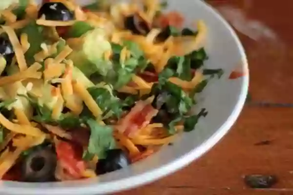 Low carb avocado breakfast bowl is full of yummy ingredients like bacon, avocado, and cheese. From lowcarb-ology.com