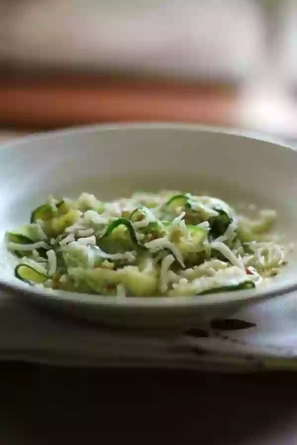 This low carb zucchini pappardelle is covered in a light, garlicky olive oil. Quick and easy! From Lowcarb-ology.com