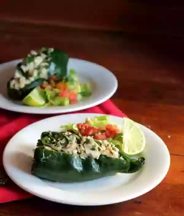 These low carb tuna stuffed poblano peppers are full of Tex-Mex flavor. Perfect lunch on the go! From Lowcarb-ology.com