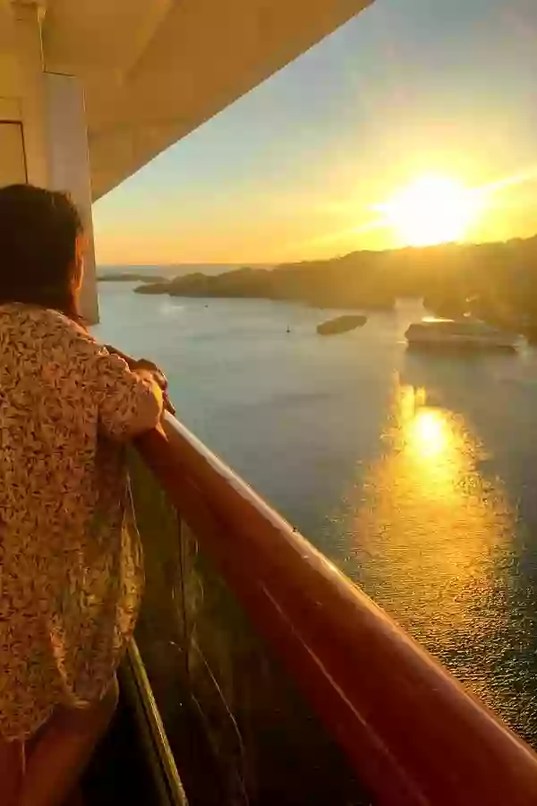 Marye Audet, Author of Tropical Mule Recipe, Standing on the Balcony of a Cruise Ship at Sunset