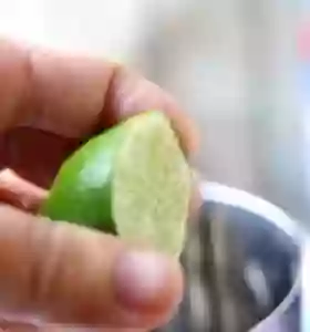 Next step is squeezing the lime and lemon into the shaker