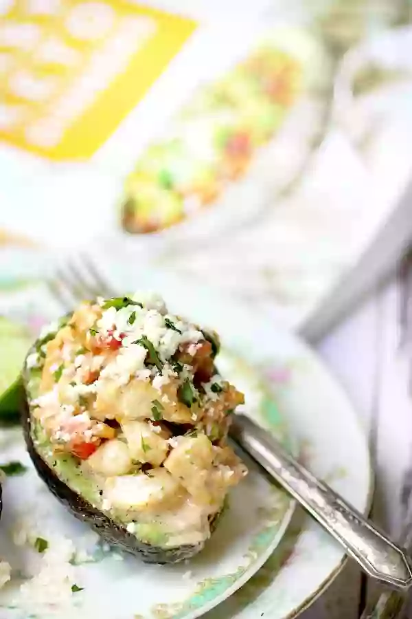 Southwestern Chicken Salad Stuffed Avocados With Easy Keto Dinners Book in the Background