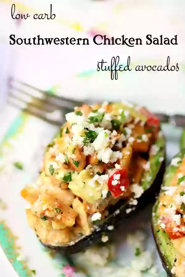 Southwestern chicken salad stuffed avocados are sprinkles with white queso fresco cheese.
