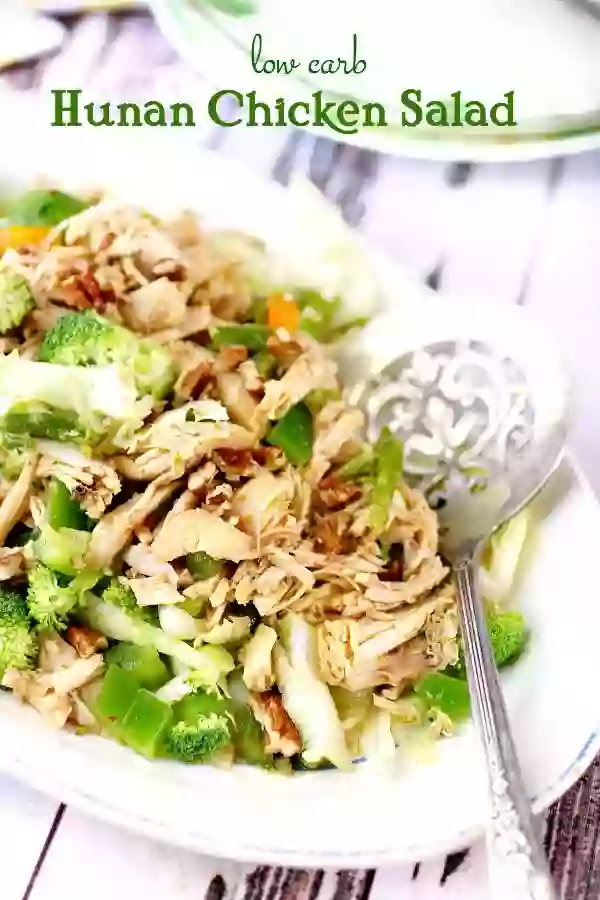 Title image for Hunan Chicken Salad -served up on a white platter with a silver serving spoon lying next to it.