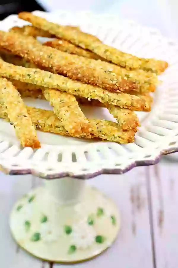 A close up image of low carb cheese straws on a white plate