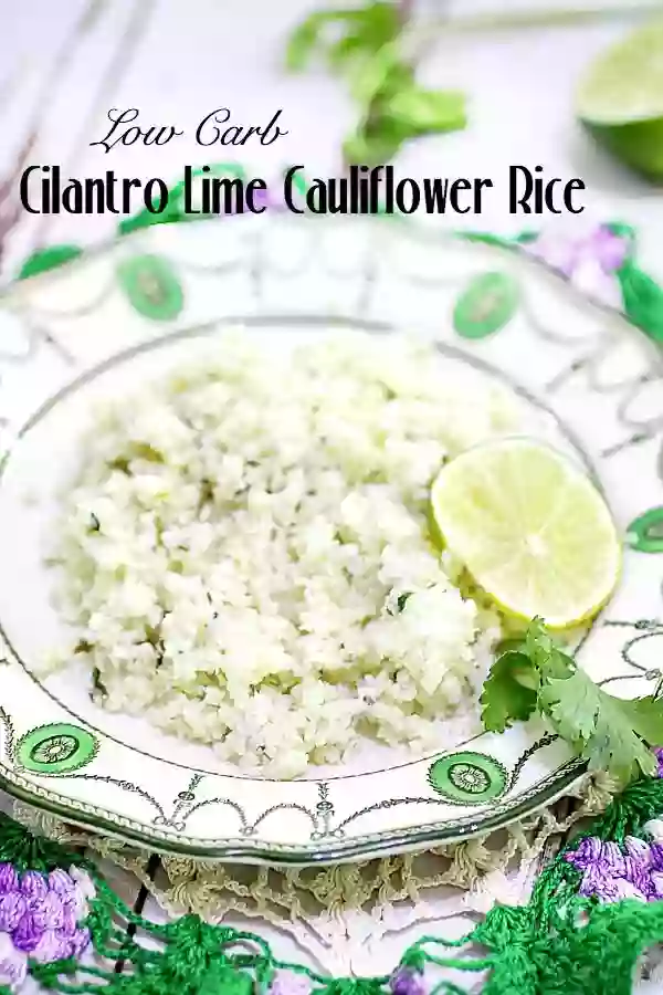 cilantro lime cauliflower rice on an vintage green and white plate- garnished with a lime slice and cilantro.