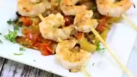 Closeup of grilled shrimp on a bed of roasted tomato relish