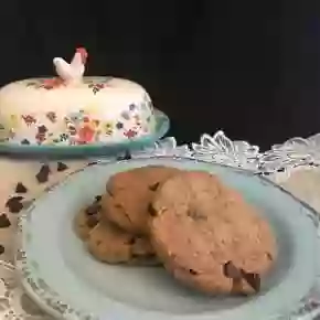 keto cookies with chocolate on blue plate with country butter dish in background