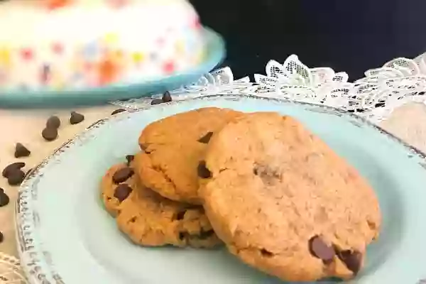 Big, chewy peanut butter chocolate cookies on an aqua plate