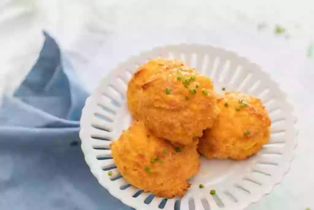 Keto Cheddar Biscuits on a white decorative plate.