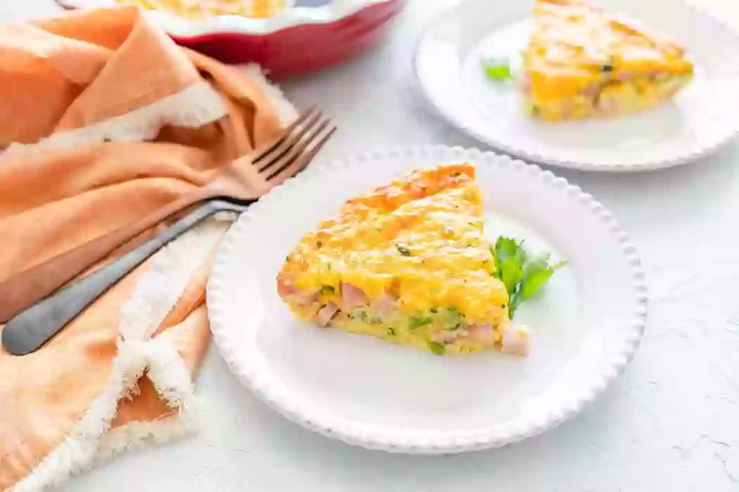 A slice of Keto Frittata on a white place