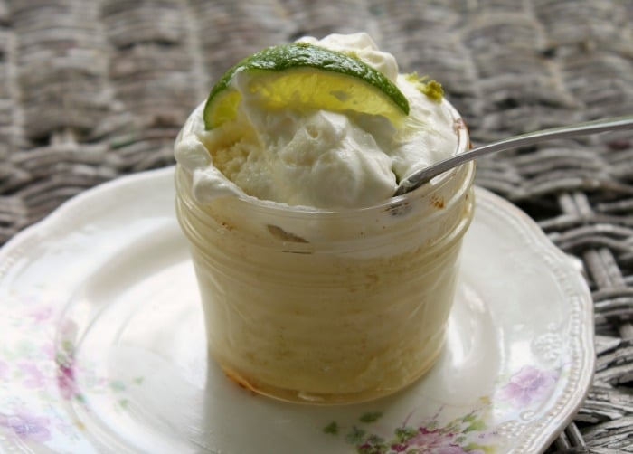 Low Carb Crustless Key Lime Pie in a jelly jar with a spoon in it sitting on one of my decorative plates.  I made this recipe for lowcarb-ology.com 