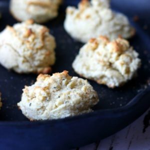 Baked sour cream biscuits with golden brown tops in a skillet