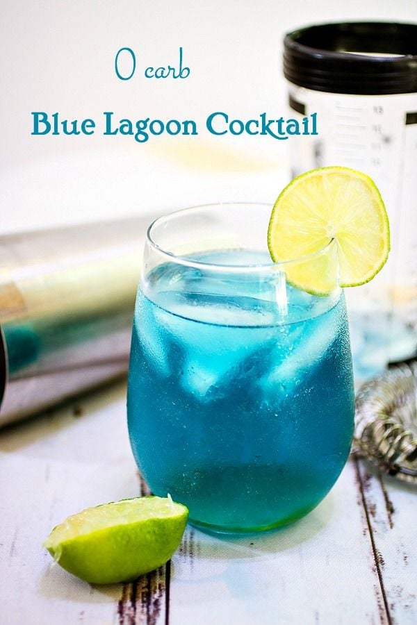 Blue Lagoon Cocktail Title Image - A Caribbean blue cocktail garnished with lime on a chippy painted white table.